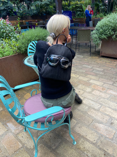 Small denim backpack with glasses